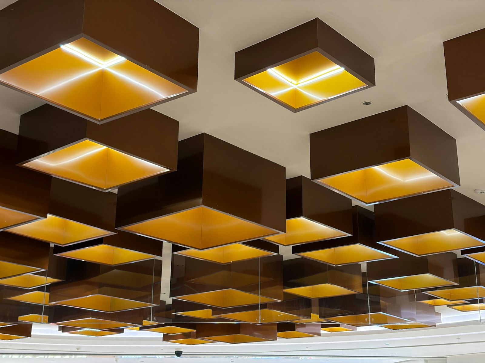 A commercial ceiling of illuminated square light panels